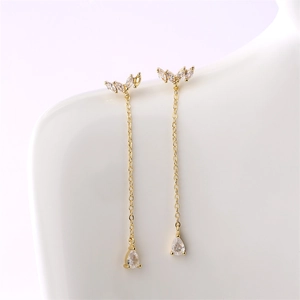 Detail of gold-plated geometric tassel earrings with marquise and teardrop zircons