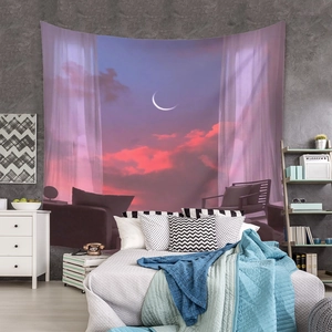 Detail of bohemian sunset landscape tapestry hanging on a modern bedroom wall