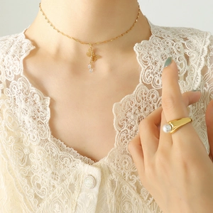 Elegant butterfly pendant necklace with zircon tassels and pearl ring on female model