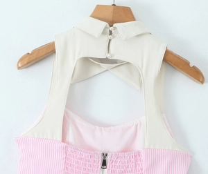 Detail view of y2k backless halter top with pearl buttons and striped fabric pattern