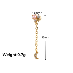 Detail view of 31mm long gold drop earring with pink bead and star crescent pendants