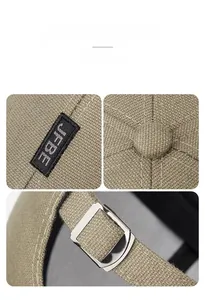 Detail of khaki outdoor baseball cap showing cotton twill fabric and adjustable metal buckle