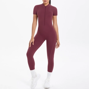 Close-up of wine red short sleeve yoga bodysuit featuring half-zip collar and slim fit cut
