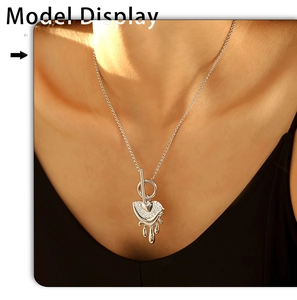 Detail view of a silver melting heart pendant necklace with rhinestones on a model's neck