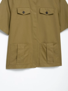 Detailed view of khaki utility shirt with buttoned flap pockets and pleated hem detail