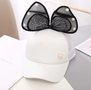 Detail of white baseball cap featuring large black mesh bow and pearl Mickey silhouette
