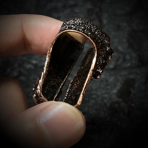 Detailed view of vintage bronze wide ring with textured surface and antique finish