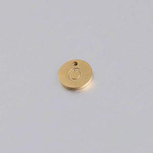 Macro di ciondolo tondo in oro acciaio inox con lettera C incisa e finitura spazzolata