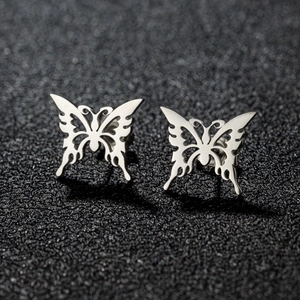Detailed macro view of silver stainless steel butterfly stud earrings with hollow design