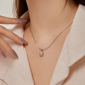 Detailed view of silver necklace with rectangular multi-color cubic zirconia pendant
