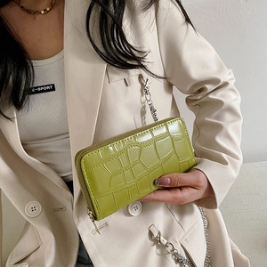 Close-up of green crocodile texture PU leather wallet with detachable metal chain strap