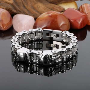 Detail showing skull elements and bicycle chain design in polished stainless steel