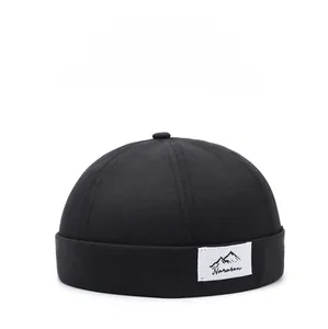 Detail view of the black breathable brimless docker hat with Narason brand logo patch