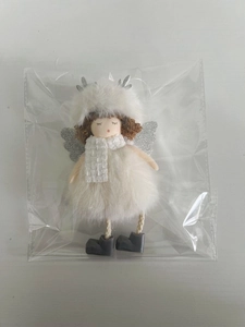 Detail of a white plush Christmas angel doll with silver antlers in a clear package