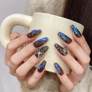 Translucent black press-on nails with aurora blue glitter and 3D metal butterfly charms