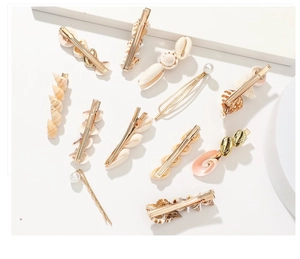 Flat lay of 11pcs set with natural seashells, pearls, and gold metal hair clips