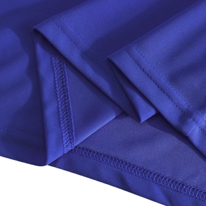 Macro shot of navy blue breathable mesh fabric and durable double-stitched hem on polo shirt