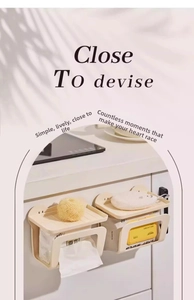 Wall-mounted cream tissue box with top shelf holding cleaning supplies and towels