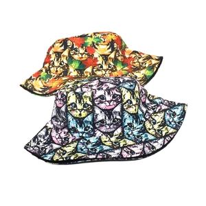 Double-sided reversible bucket hats featuring maple leaf and colorful cat graffiti prints