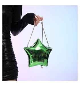 Star shaped bright green acrylic evening bag with silver chain held by a model