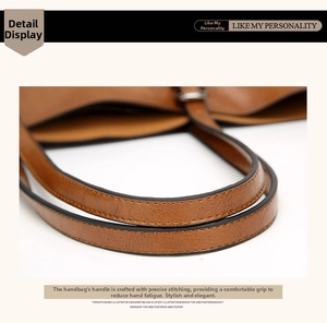 Close-up of caramel brown leather handle with precise stitching and oil edge finish