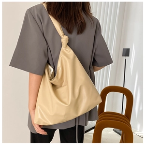 Fashionable large capacity PU leather tote bag shown on model for size and style