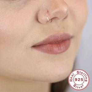 Detail of 925 sterling silver gold nose ring on model with certified silver stamp