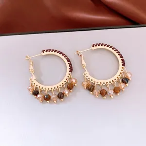 Ethnic style round hoop earrings with colorful glass beads and dark brown woven rope detail
