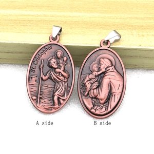 Detail view of bronze metal Saint Christopher pendant showing A side and B side reliefs