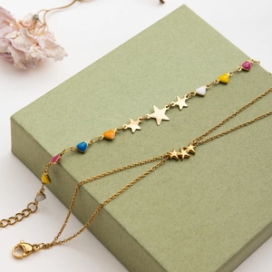 Detail of 18K gold stainless steel bracelets with colorful enamel hearts and stars