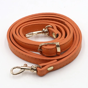 Detail of adjustable orange PU leather shoulder strap with golden swivel hooks