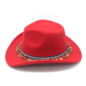 Detailed view of red western cowboy hat with bohemian beaded fringe and ethnic band