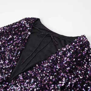 Detail of purple and black sequins on the V-neckline with black tie lace-up closure