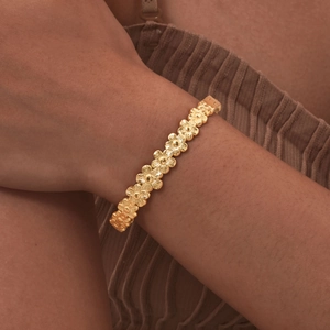 Elegant gold-tone vintage flower cutout bangle bracelet for women in polished finish