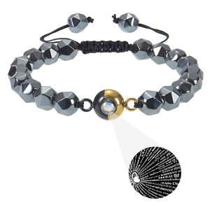 Macro detail of faceted tiger eye beads and projection stone on adjustable woven bracelet