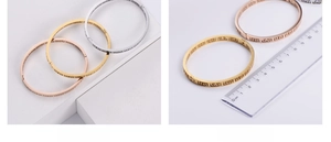 Detailed view of gold, silver, and rose gold cutout bangles with size measurements