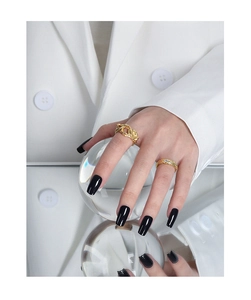 Detailed view of gold plated hollow interwoven ring and zircon band on hand