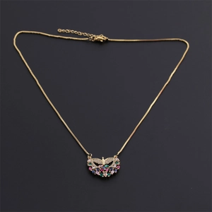 Golden necklace featuring a wing-shaped pendant with vibrant multi-colored cubic zirconia