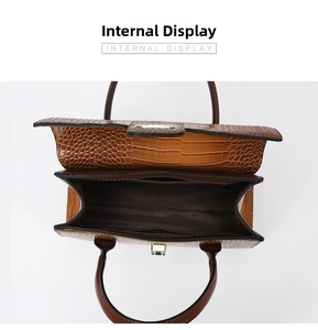 Macro view of a large capacity tote showing multiple interior compartments and brown lining