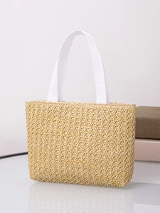 Detailed macro view of woven plant fiber texture and white webbing handles on tote bag
