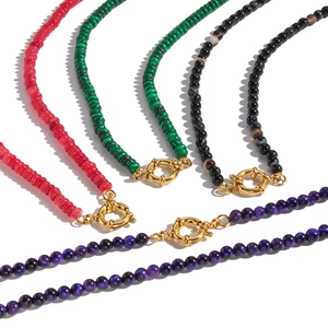 Vintage style beaded stone necklaces in four colors with gold clasps on white background