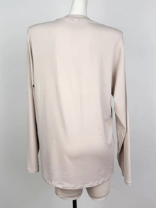 Rear view of a light beige long-sleeve loungewear set on a mannequin with soft fabric texture