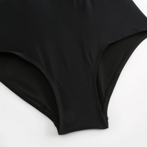 Detailed close-up showing the double-stitched seams and elastic fabric of the black swimsuit