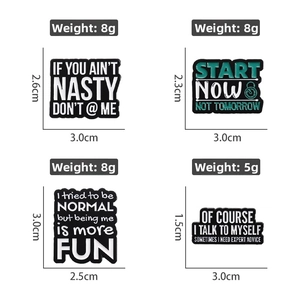 Detail view of four enamel pins with motivational text and precise measurements
