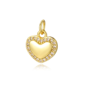 Gold heart pendant with tiny crystals around a polished surface on white background