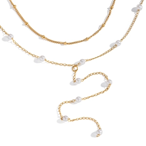 Detail view of double-layered Y-shaped gold necklace with elegant small white pearls