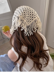 Detailed macro view of the cream crochet hollow-out pattern and boho fringe tassel on bandana