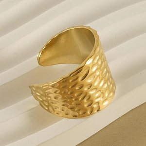 Detailed view of the 18K gold plated wide band ring with hammered metal texture