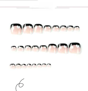 Detail view of black French press-on toenails with white heart patterns in various sizes