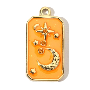 Detailed macro view of orange enamel star and moon square pendant in gold finish